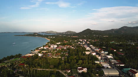 Panoramic-aerial-view-of-Koh-Samui-island-coastline-during-sunset,-Thailand