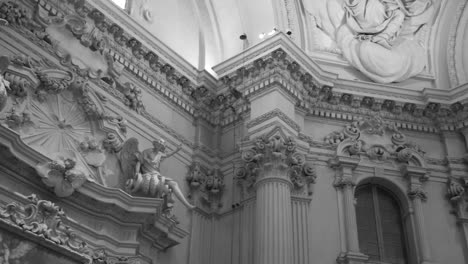 low angle black and white shot of beautiful interiors of sanctuary of santa maria della vita in bologna, italy at daytime