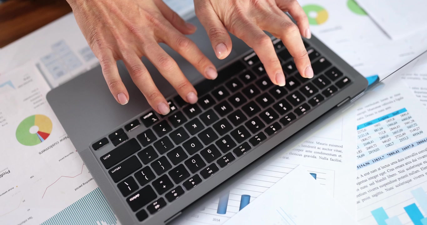 Female hands typing on computer keyboard at table in office closeup 4k movie slow motion