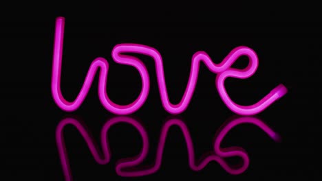 Animation-of-pink-neon-lights-forming-love-text-over-black-background