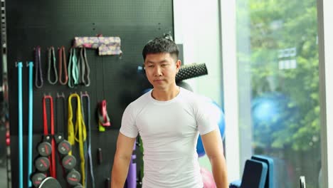 a man in a gym executes a barbell deadlift with focus. bright lighting highlights the equipment and his form