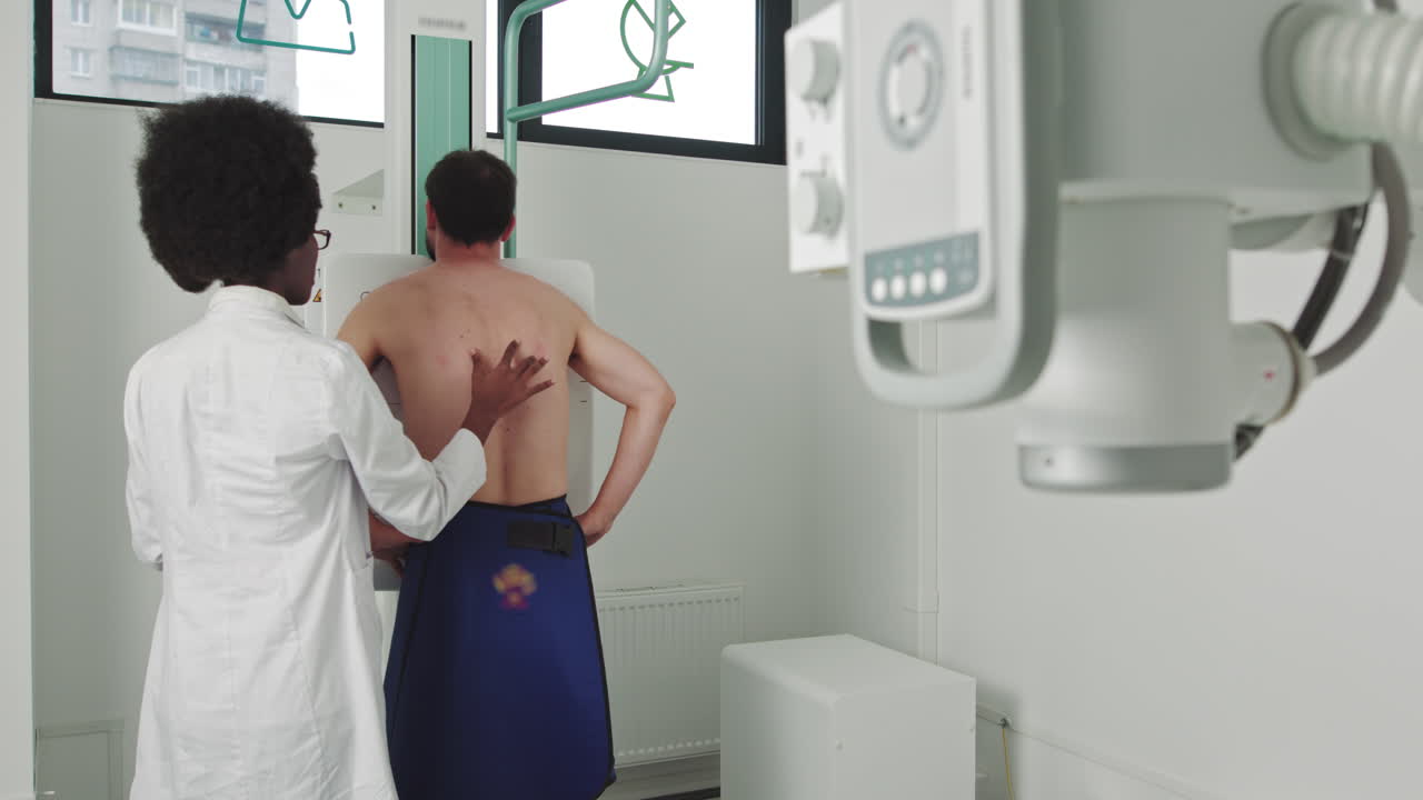 Scanning for fractures broken limbs chest cancer or tumor in the hospital man standing face against