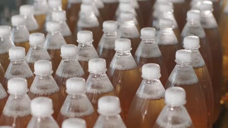 conveyor belt with bottles for juice or water at a modern beverage plant. modern production of sweet soda water