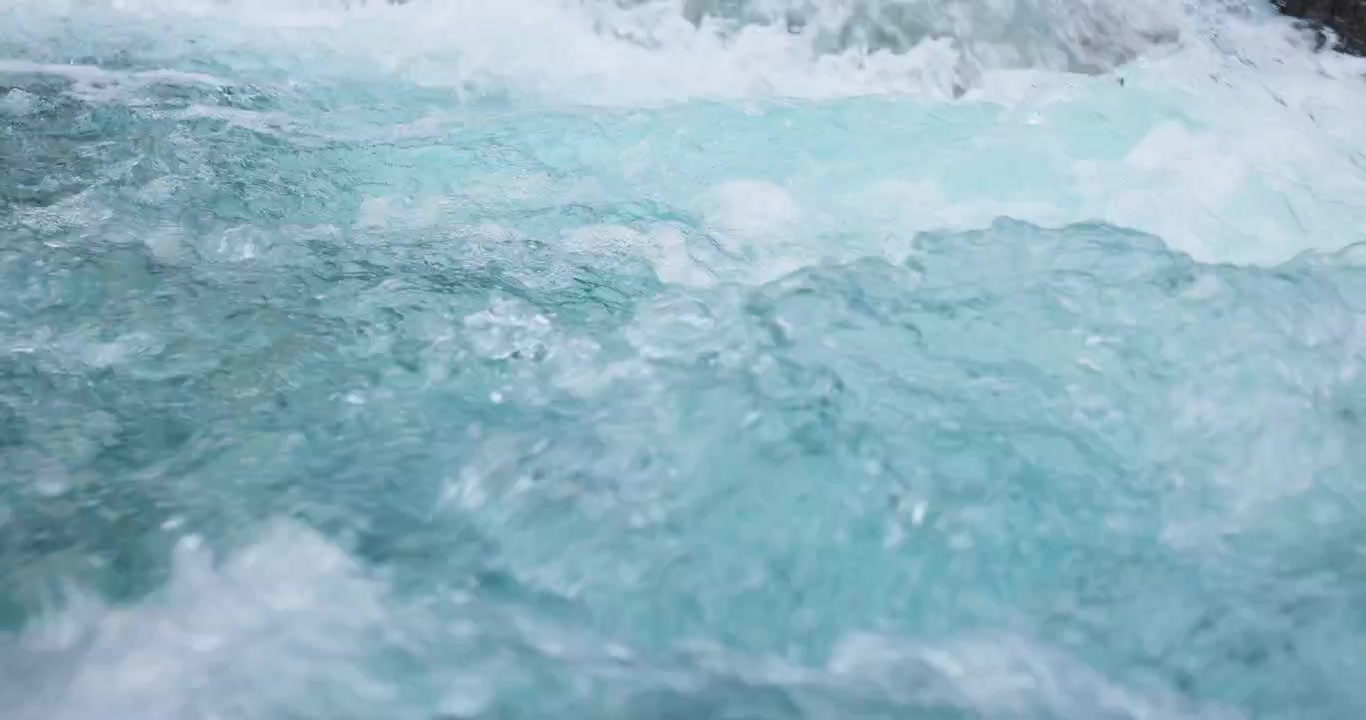 Lush pure turquoise glacial melt water pour down Norway river in slow motion