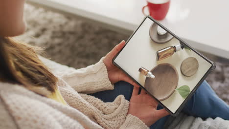 Caucasian-woman-using-tablet-at-home-for-online-shopping,-slow-motion