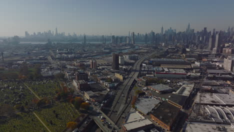 Aerial-panoramic-view-of-metropolis.-Industrial-suburb-and-downtown-business-towers-in-distance.-New-York-City,-USA