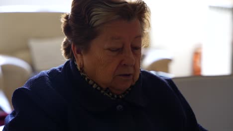 close up of cheerful granny talking about something while doing household chore