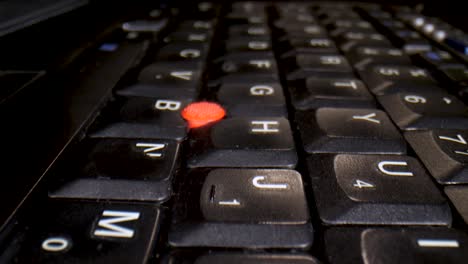Macro slow travel over an empty laptop keyboard in a dark room