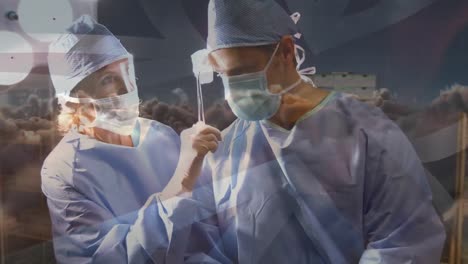 Animation-of-uk-flag-over-doctors-during-surgery