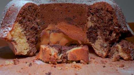 traditional marble cake on wooden plate, wonam slicing up a cake, cutting cake with knife