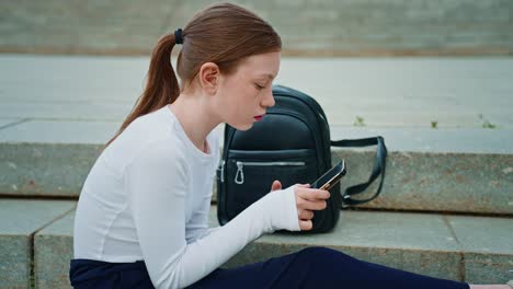 girl using smartphone on stairs