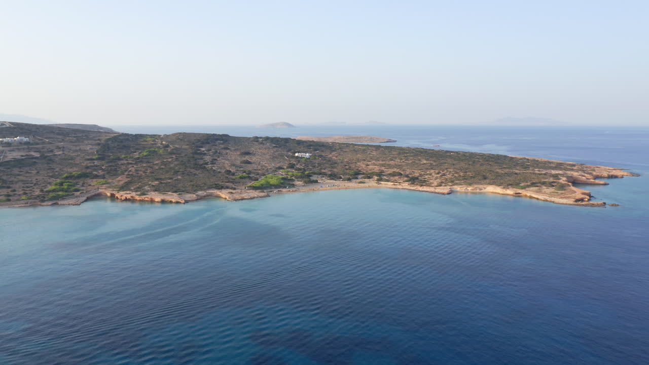 Aerial view of Italida Beach, Koufonisia. A pristine summer paradise with turquoise waters, golden sand, and sunbathers enjoying the crystal-clear Aegean