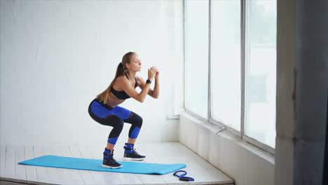woman exercising near a window