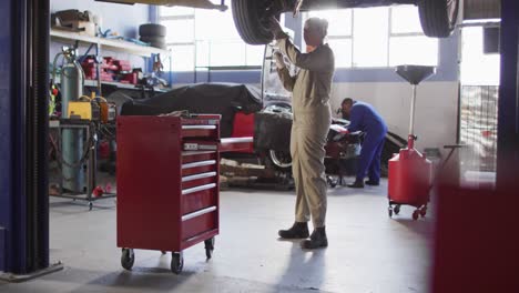 video of biracial female car mechanic changing tyre