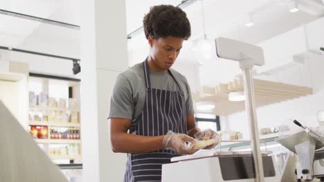 animation of focused biracial waiter weighting cheese