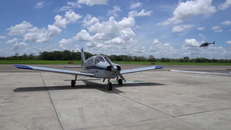 plane on runway and helicopter passes in slow motion