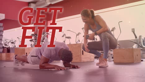 animation of get fit text over diverse man and woman exercising in gym