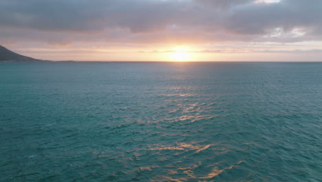 Watching-whales-in-natural-environment-at-dusk.-Fly-above-sea-surface-against-setting-sun.