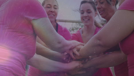 joining hands, women in pink shirts with colorful animation light effects