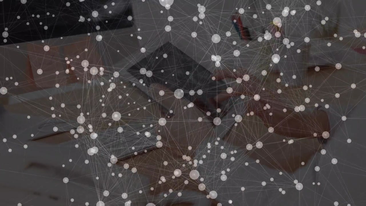 Animation of network of connections with icons over hands using tablet