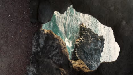 Vertical-footage-of-waves-crashing-against-rock-formation-in-Tenerife