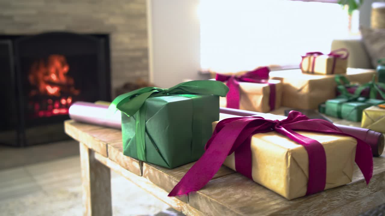 Camera is panning and zooming in on gift boxes and highlighting ribbon textures for holiday display