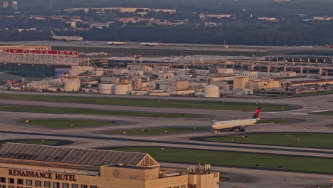 Atlanta-Georgia-Aerial-v967-zoomed-shot-at-College-Park-capturing-ATL-Hartsfield-international-airport-terminal,-Delta-Tech-Ops-hangar-and-aircraft-on-runway---Shot-with-Mavic-3-Pro-Cine---June-2023