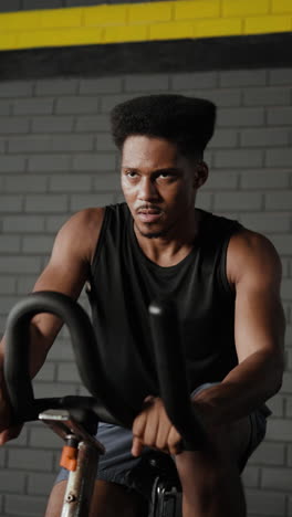 man working out on a stationary bike in a gym