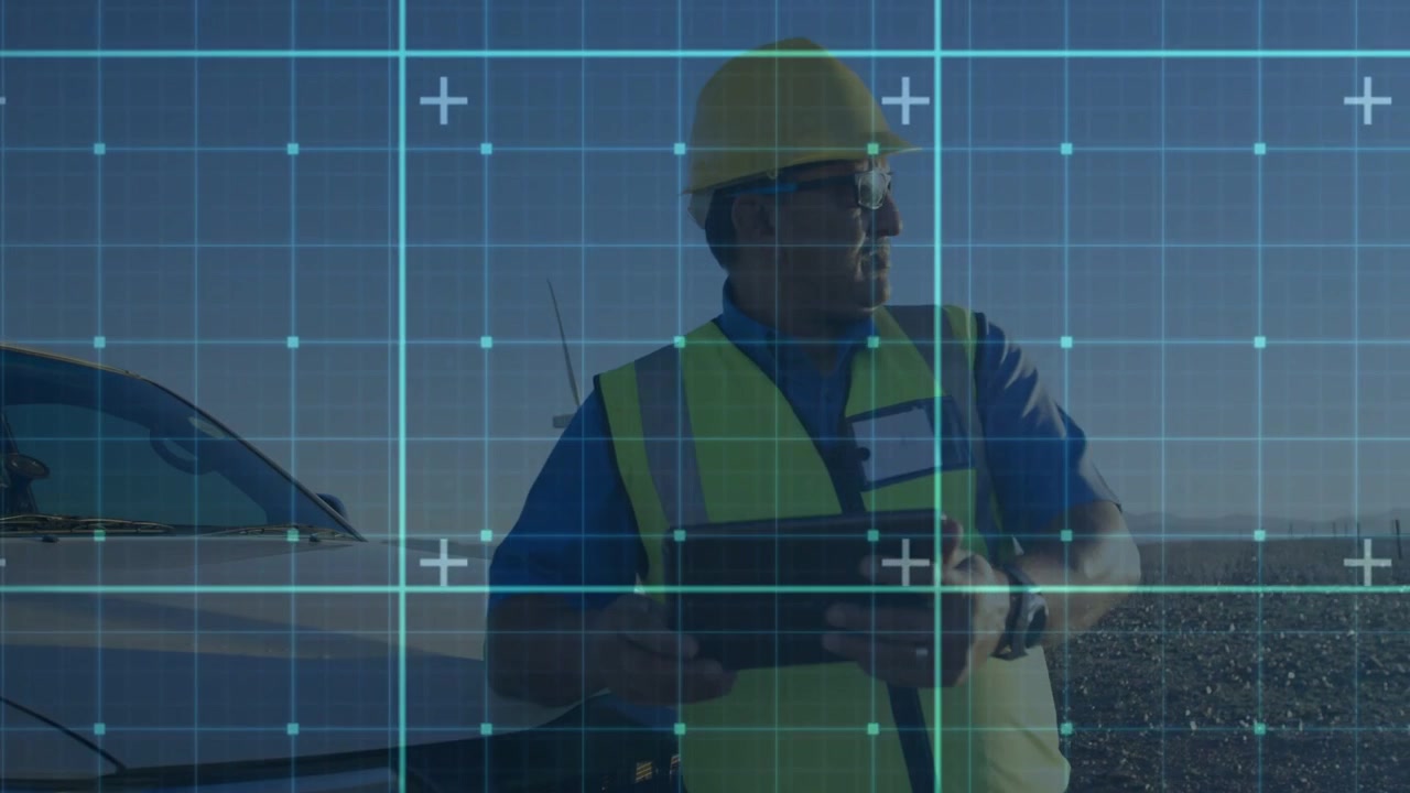 Technician tapping tablet and checking watch, inspecting wind turbines with blue grid across frame
