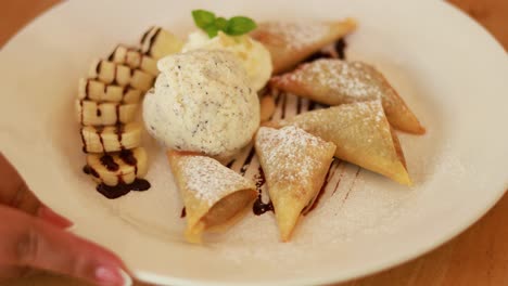 delicious fried pastry with ice cream and banana