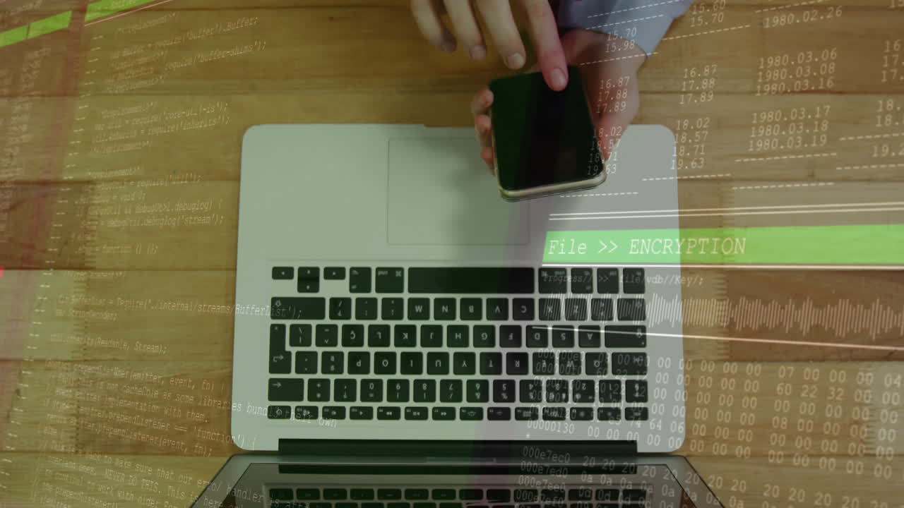 Hands holding smartphone over laptop with encryption data processing animation
