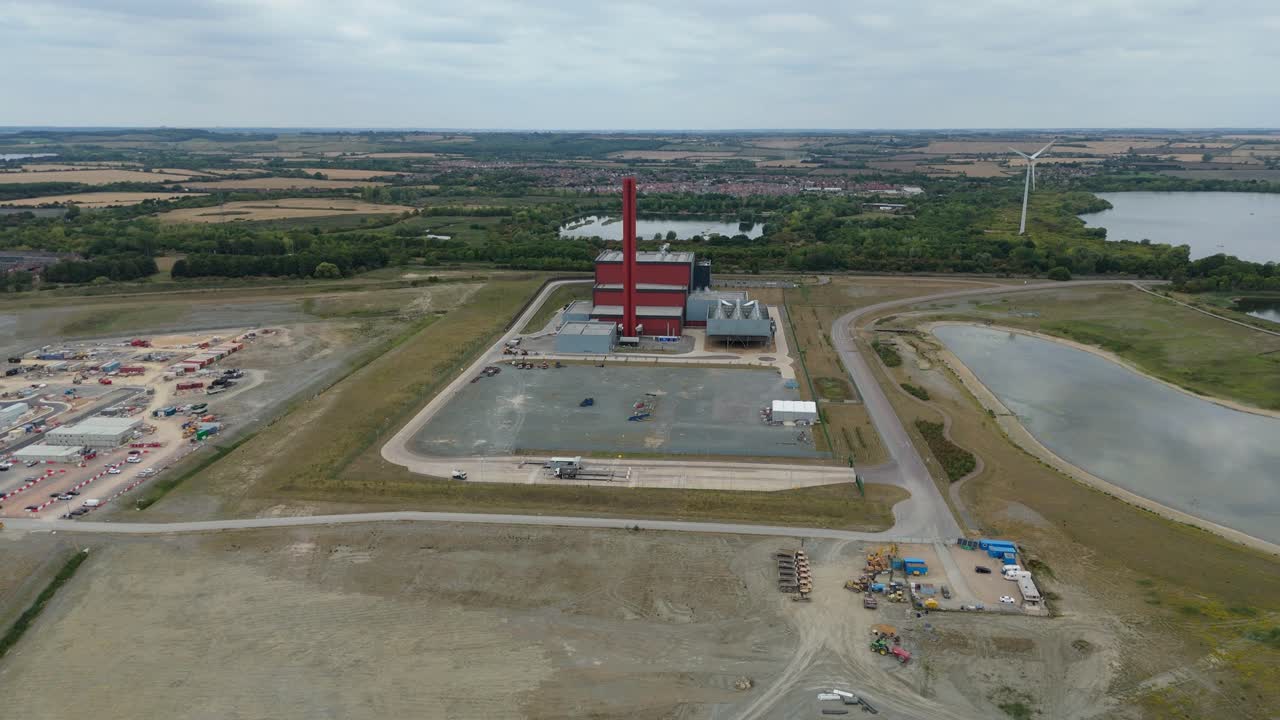 Drone aerial view of Bedford fossil fuel power station with chimney stacks, energy generation facilities and large-scale industrial infrastructure UK