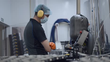 factory worker monitoring machinery