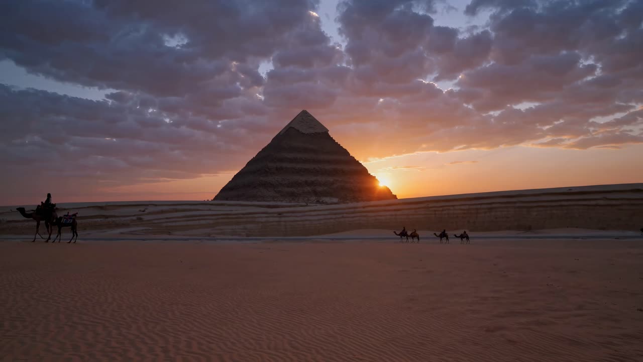 A stunning sunset video captures a low-angle view of camels and a pyramid, with dramatic clouds