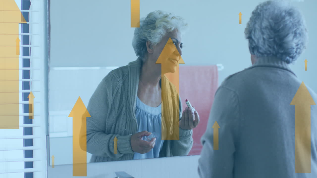 animación de múltiples flechas hacia arriba sobre una mujer biracial sonriente aplicando lápiz labial frente al espejo