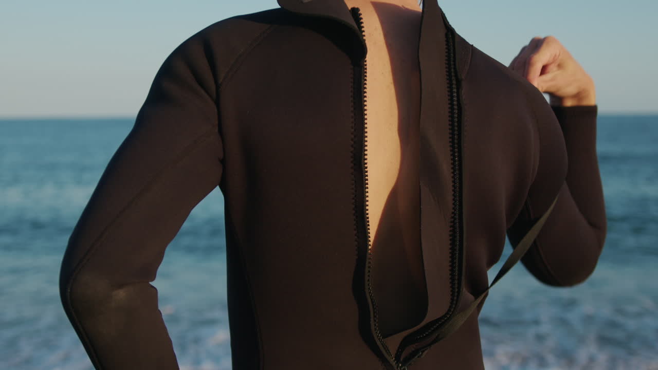 Surfer man walking to the beach at sunset preparing for surfing training and search for waves in Barcelona, spain, water, ocean exercise in sea with board, athletic male holiday or travel in vacation