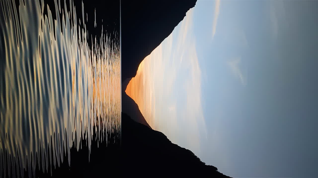 Vertical footage of calm still lake at sunset in Milford Sound, Fiordland new Zealand nz