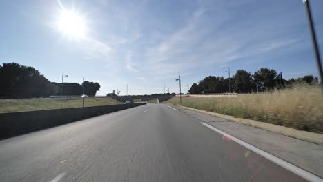 driving on a empty road entering montpellier city during lockdown france sunny