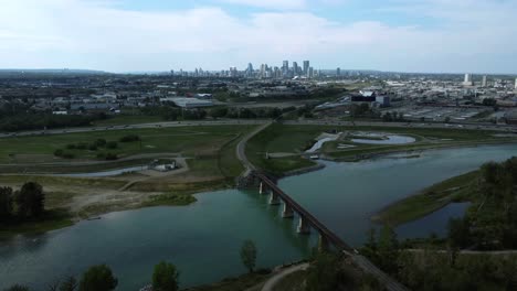 Aerial-view-of-downtown-cityscape,-industrial-area,-and-highway,-Calgary,-Alberta,-Canada