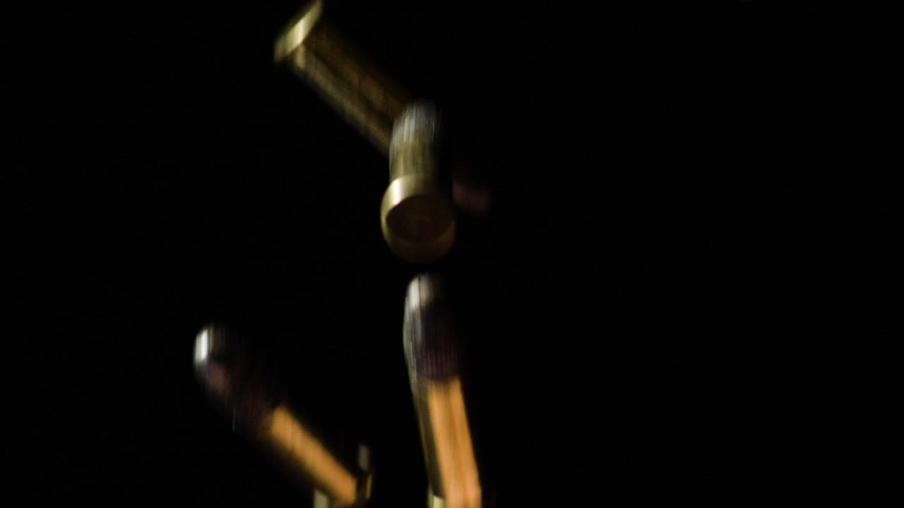 9mm Parabellum Firearm Cartridges Falling Against Black Background