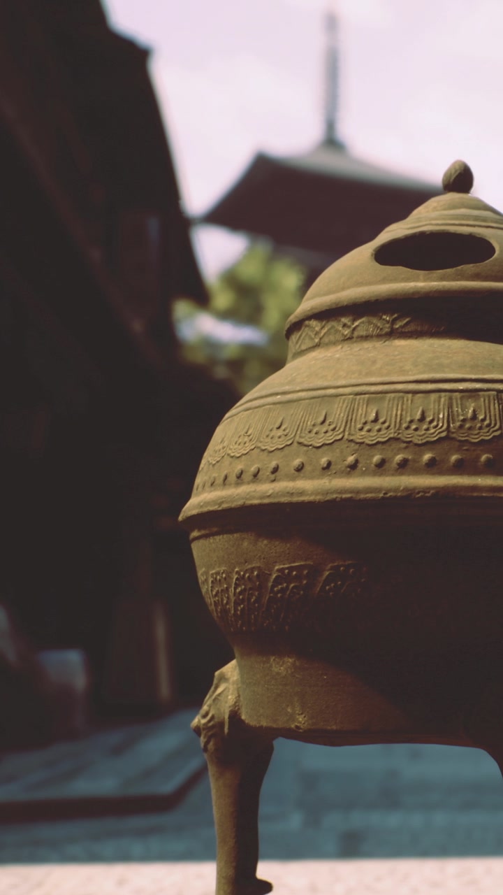 Bronze incense burner at temple street in historic district during afternoon