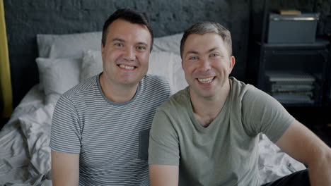 happy gay couple in bedroom