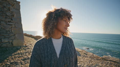 calm woman contemplating ocean waves at evening closeup. relaxed girl on beach