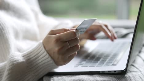 female hands holding credit card and using laptop. online shopping