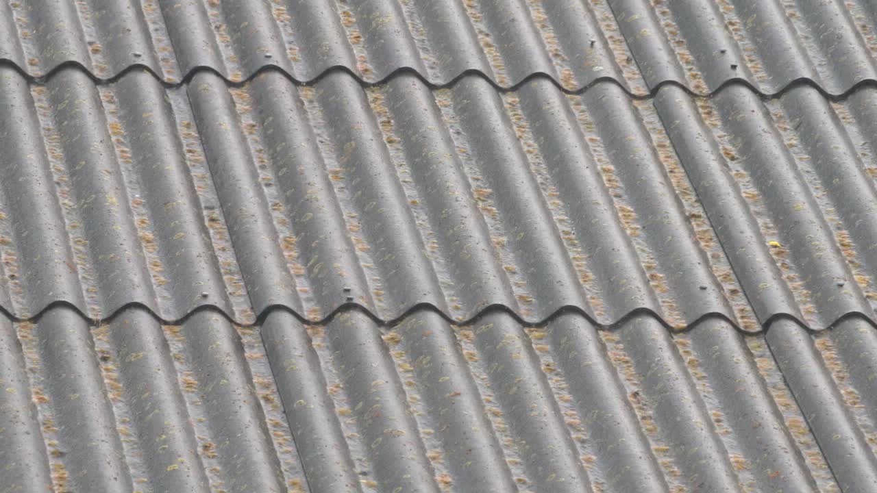 Roof tiles arranged in patterns with some debris present