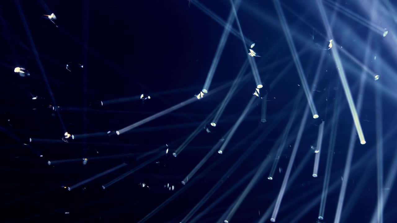 4K Defocused abstract moving cool white lights effect from ceiling and wall lamp in the room.