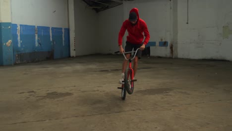 bmx rider in an empty warehouse