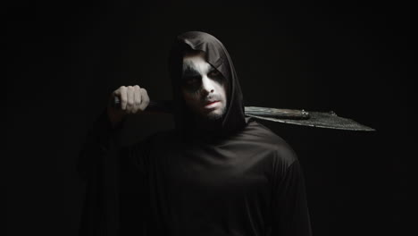 grim reaper over black background with axe in his hands