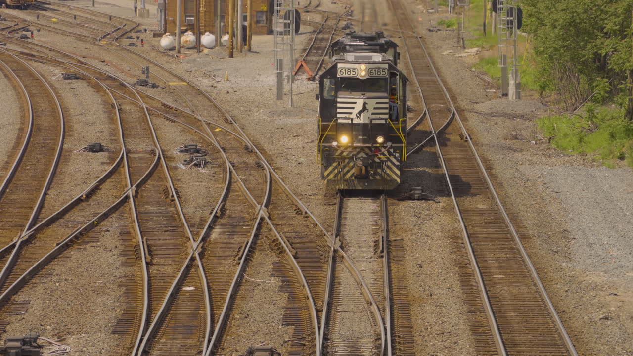 철도 열차 엔진 이 고속도로-철도 등급 교차로 에 접근 하고 빛 을  ⁇ 박이고 있다