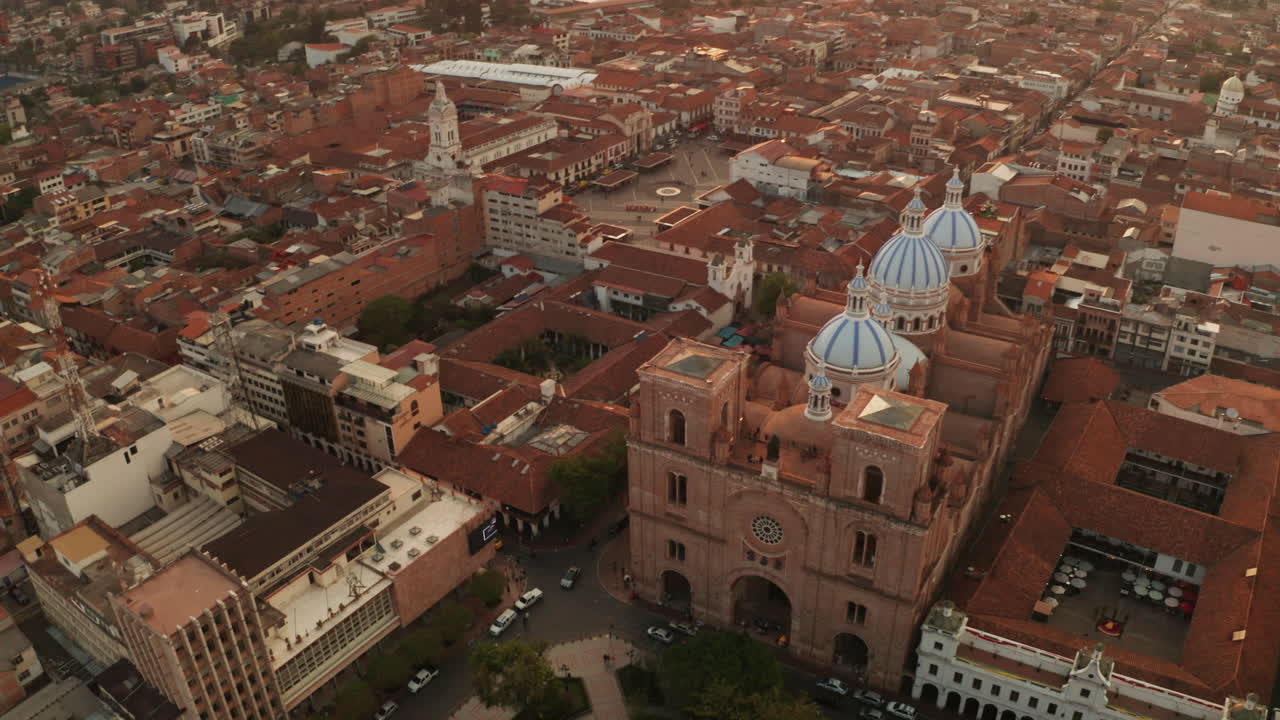 Stunning panoramic view of the historic center of Cuenca, Ecuador, with a focus on the majestic blue domes of the Cathedral of the Immaculate Conception.